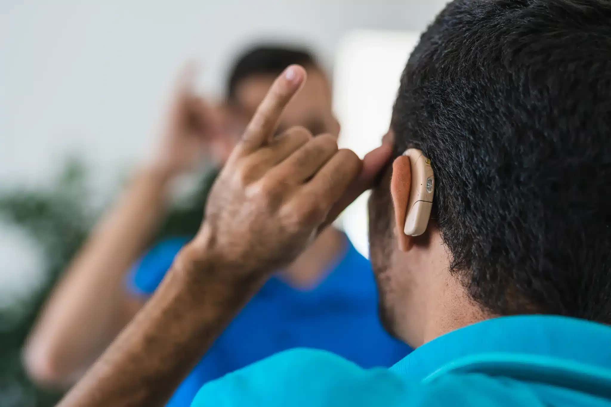A deaf man with his back turned