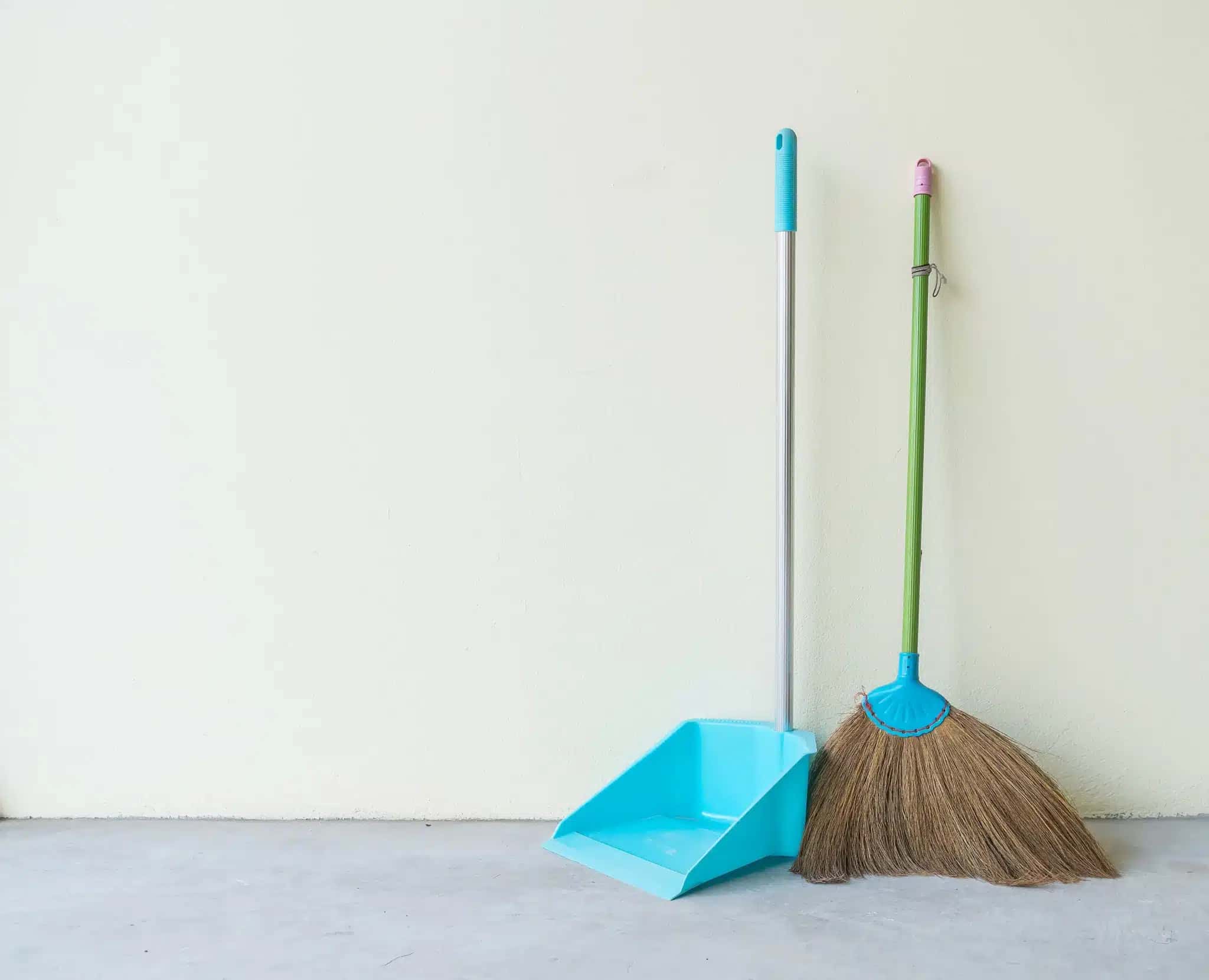 Dust Pan and Broom with wall background