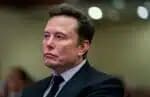 Elon Musk listens as US President-elect Donald Trump speaks during a meeting with House Republicans at the Hyatt Regency hotel in Washington, DC on November 13, 2024. (Photo by Allison ROBBERT / POOL / AFP)