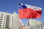 A supporter of Chile's new President Gabriel Boric holds a Chilean flag while waiting for his arrival to La Moneda Palace after his inauguration in Santiago, on March 11, 2022. Leftist former student leader Gabriel Boric sworn in Friday as Chile's youngest-ever president, with plans to turn the country that for decades has served as a neoliberal laboratory into a greener, more egalitarian "welfare state." (Photo by Pablo Vera / AFP)