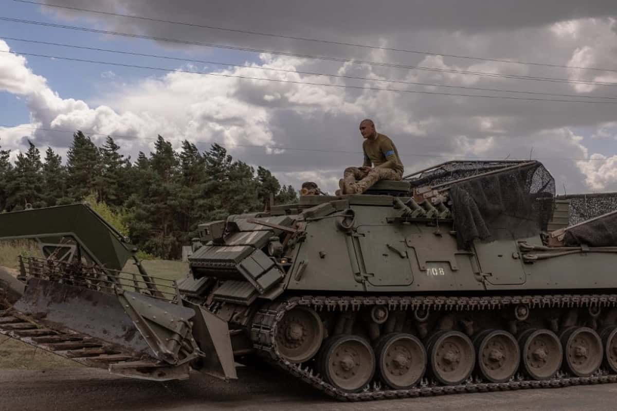 Ukrainian servicemen operate an armoured military vehicle in the Sumy region, near the border with Russia, on August 13, 2024, amid the Russian invasion of Ukraine. Ukraine's shock border offensive into Russia's Kursk region has been one of Ukraine's speediest operations since Moscow invaded in February 2022. Analysts say it is the most significant ground operation by a foreign army inside Russia since World War II. For Ukraine, it has been a morale boost at an otherwise perilous moment in the war. (Photo by Roman PILIPEY / AFP)
