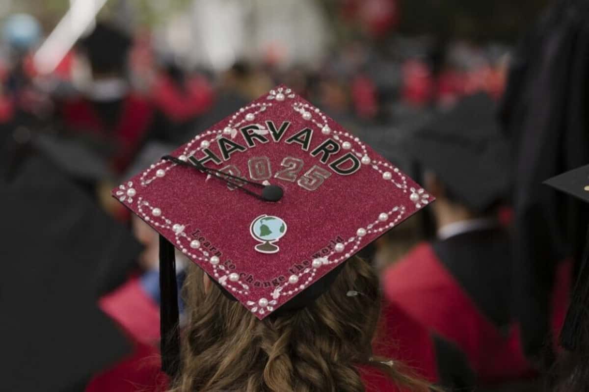 CAMBRIDGE, MASSACHUSETTS - MAY 29: A graduate's cap reads "Learn to Change the World" during Harvard's commencement ceremony on May 29, 2025, in Cambridge, Massachusetts. The joyous occasion unfolds amid escalating tensions between Harvard and the Trump administration, which has ordered the cancellation of federal contracts valued at approximately $100 million. Libby O'Neill/Getty Images/AFP (Photo by Libby O'Neill / GETTY IMAGES NORTH AMERICA / Getty Images via AFP)