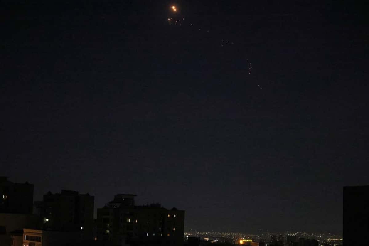 Iranian air defences reportedly intercept Israeli projectiles over the capital Tehran on June 13, 2025. Israel vowed to press on with "full force" on June 13 after its unprecedented onslaught on Iran that killed several of the country's top military brass, with media in the Islamic republic reporting strikes and projectiles well into the evening. (Photo by Atta KENARE / AFP)