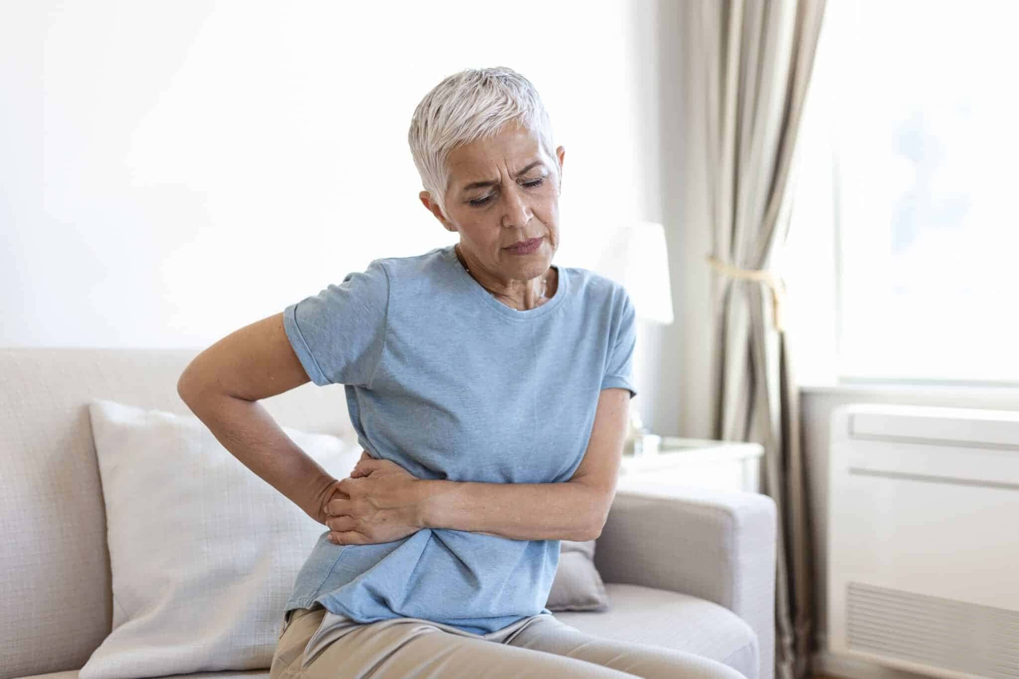 unhealthy-mature-woman-holding-belly-feeling-discomfort-health-problem-concept-unhappy-older-female-sitting-bed-suffering-from-stomachache-food-poisoning-gastritis-abdominal-pain-climax-1