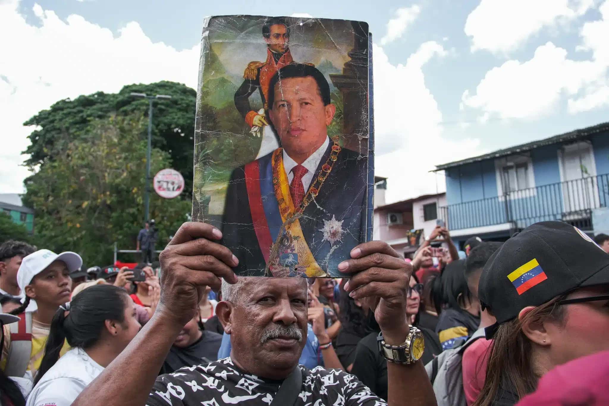 Cidadão segura foto de Hugo Chávez no ato de celebração do seu 72º aniversário, em Caracas.