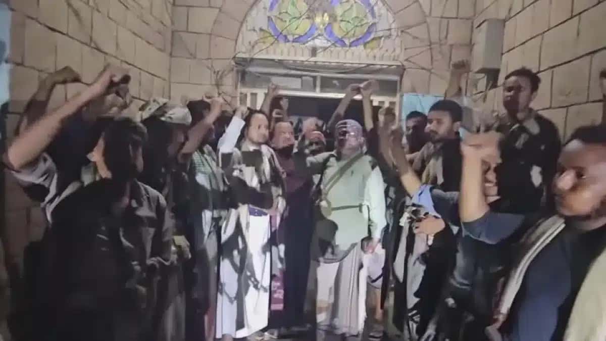 Os houthis comemoram em frente ao prédio da diretoria de segurança em Hays, cidade estratégica do Iêmen. (10.09.26)