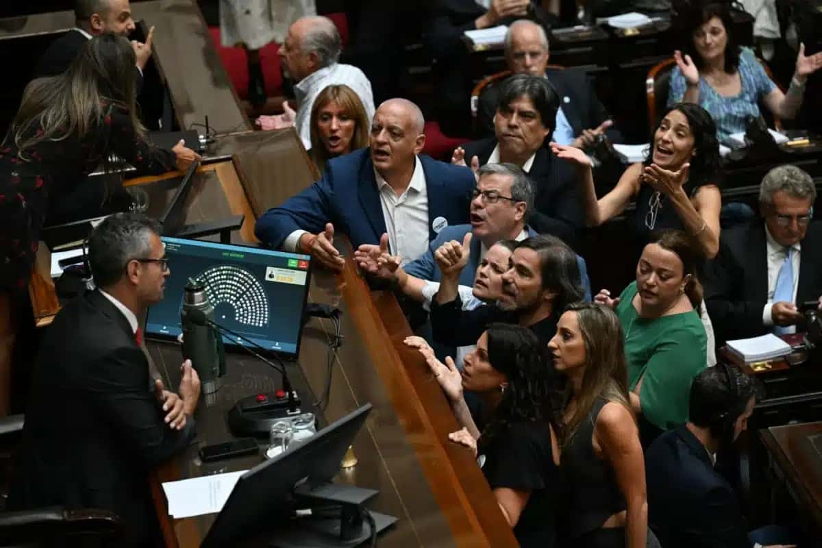 Deputados da oposição discutem com o presidente da Câmara dos Deputados da Argentina, Martín Menem, durante uma sessão para debater as reformas da lei trabalhista no Congresso Nacional, em Buenos Aires, em 19 de fevereiro de 2026 | Foto: Luis Robayo / AFP