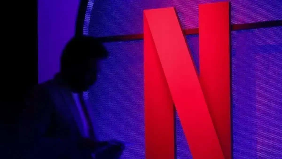 Um homem ao lado do logotipo da Netflix durante um evento em Mumbai.